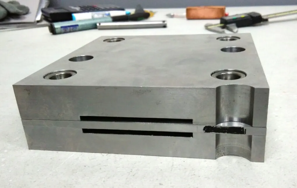 Precision-machined die block with countersunk bores on the inspection bench
